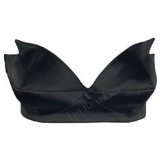 Presenting a stunning black satin Thierry Mugler pointed bralette, designed by Manfred Mugler. From the 1980s, this bralette is constructed entirely of shiny black satin. The bralette features a sweetheart cut and is made complete with pointed accents on either cut, giving this bralette an undeniable Mugler touch. A must-have for any Thierry Mugler lover, this bralette can be sported on its own or layered with your favorite blazer. Approximate measurements: Size - 42FR Top of bust to hem: 5" Bus Black Crop Top With Built-in Bra For Evening, Party Satin Crop Top With Built-in Bra, Chic Silk Crop Top For Evening, Elegant Satin Crop Top For Party, Fitted Silk Crop Top For Evening, Chic Satin Crop Top For Evening, Chic Silk Crop Top For Party, Elegant Satin Crop Top For Evening, Fitted Silk Crop Top For Night Out