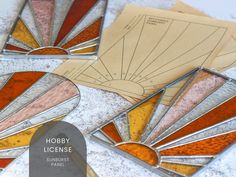 four stained glass coasters with the words hobby license on them and an image of a sunburst