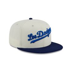 a white and blue hat with the word los dodgers on it