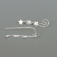 Sterling silver ear climber with tiny stars. This listing is for ONE PAIR Size: 22 x 5 mm These earrings are made of real 925 hypoallergenic sterling silver. All my pieces are sent in a gift box. I can include a personal message from you if needed You are welcome to contact me at... bhavnakwintra1956@gmail.com For more beautiful pieces from my shop, please browse 👇 TOE RINGS: https://www.etsy.com/your/shops/TheSilverGame/tools/listings/section:27020628,view:table EAR HOOPS: https://www.etsy.com Star-shaped Ear Climbers As Gift, Star-shaped Ear Climbers For Gift, Star Shaped Ear Climbers As Gift, Star-shaped Ear Climbers For Pierced Ears, Leaf Earrings Silver, Stars Earrings, Silver Ear Climbers, Silver Star Earrings, Ear Climber