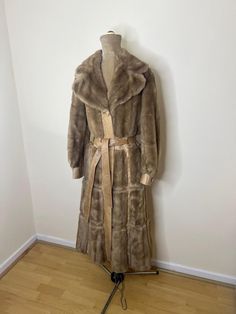 A vintage 1970's London Leathers by Lilli Ann long faux fur and leather coat. It has gold chain belt loops. Although the label doesn't say 'London Leathers' the logo is that of the brand.   UK Size 8. Please check measurements: Chest - 88cm Waist - 80cm Hips - 98cm Length - 115cm 1970s London, Gold Chain Belt, Lilli Ann, Chain Belt, Faux Fur Coat, Leather Coat, The Label, Gold Chain, Gold Chains