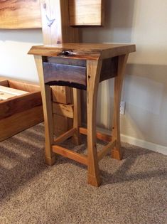 a small wooden table sitting on top of a carpeted floor