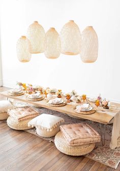 a long table with several stools on top of it in front of hanging lights