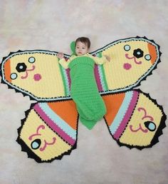 a small child laying on top of a butterfly rug