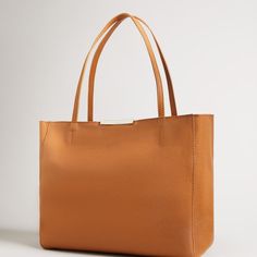 Perfect Bag To Go With Your Fall Outfits Leather Tote Bag In A Stunning Tan Color. The Bag Has Gold Hardware With Ted Baker Branding. Corners Have Minor Wear As Pictured. The Bag Is Otherwise In Perfect Condition And Still Has The Original Tags. Classic Tan Box Bag For Shopping, Top Handle Satchel With Smooth Grain For Shopping, Top Handle Smooth Grain Satchel For Shopping, Smooth Grain Top Handle Satchel For Shopping, Luxury Tan Everyday Bag, Tan Textured Leather Shoulder Bag For Work, Tan Textured Leather Shoulder Bag For Daily Use, Tan Textured Leather Tote Bag, Textured Leather Rectangular Shoulder Bag