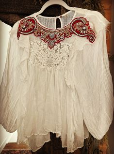 This is a one of a kind, beautiful flowing and delicate cotton/linen white blouse with its own embroidery in addition to my custom antique beading that was added. Beautiful bright reds, golds and silvers. Bohemian Blouse For Summer Weddings, Bohemian Wedding Blouse For Summer, Bohemian Summer Wedding Blouse, White Long Sleeve Blouse For Festive Occasions, Bohemian Off White Top With Floral Embroidery, White Tops With Intricate Embroidery For Festive Season, White Blouse With Floral Embroidery For Wedding, White Floral Embroidered Blouse For Wedding, Embellished White Blouse For Summer