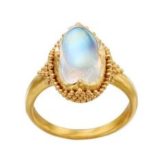 Java is a luminous natural blue moonstone cabachon ring. The exceptional glowing blue white gem is mounted in an exceptional 22k yellow gold mounting embelished with painstaking granulated gold in the Etruscan style. Inspired by the jewelry of antqiuity and hand crafted in Bali. Gold Ethiopian Opal Heirloom Rings, Heirloom Gold Opal Cabochon Ring, Heirloom Gold Opal Ring With Cabochon, Heirloom Ethiopian Opal Gold Rings, Celestial Style Oval Cabochon Gemstone Ring, Luxury Gold Opal Ring With Cabochon, Celestial Oval Cabochon Gemstone Rings, Heirloom Gold Opal Gemstone Ring, Heirloom Gold Moonstone Jewelry