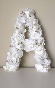 the letter is made out of white flowers