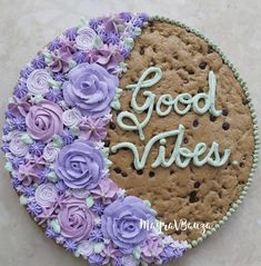 a cookie decorated with flowers and the words good vibes