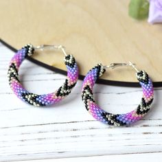 Wonderful purple hoop earrings  will be great birthday gift for women. This earrings is made of highest quality Japanese Toho beads. â¿ Diameter of hoops : 1.6 inch â¿ 100% handmade. â¿ Packed in gift bag. You will receive the same piece as pictured!!! Piece of my soul, which I left in this work, will warm you even in the most difficult and sad days. I am sure; this earrings will become your lucky charm that you would enjoy wearing day and night. Beaded Earrings Brick Stitch, Earrings Y2k, Y2k Earrings, Colorful Geometric Pattern, Toho Beads, Birthday Gift For Women, Summer Earrings, Summer Earring, Handmade Beaded Jewelry