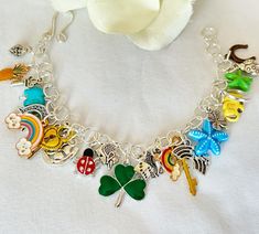 This whimsical bracelet is loaded with 25 different "lucky" charms in a variety of colors. It measures approximately 8" at the longest. Hypoallergenic Multicolor Charm Bracelet For Gift, Multicolor Themed Charm Bracelet As Gift, Multicolor Bracelets With Removable Charms For Gift, Green Charm Bracelet As A Gift, Multicolor Themed Jewelry With Charms, Themed Multicolor Jewelry With Charms, Multicolor Charm Bracelet With Removable Charms As Gift, Multicolor Hypoallergenic Charm Bracelet, Novelty Multicolor Charm Bracelet For Gift