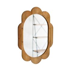 a mirror that is sitting on top of a wooden frame with an iron structure in the background