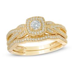 She's waited her whole life for this moment - celebrate your love with this vintage-inspired diamond bridal set. Created in warm 10K gold, the engagement ring showcases a glimmering 1/8 ct. diamond center stone. A cushion-shaped frame lined with smaller diamonds surrounds the center stone, while additional diamonds and intricate milgrain detailing adorn the ring's beautifully braided shank. On your wedding day, the coordinating contoured diamond and milgrain wedding band completes this lovely en Milgrain Wedding Band, Gold Book, Peoples Jewellers, Diamond Bridal Sets, Gold Price, Bridal Set, Bridal Sets, Diamond Stone, 10k Gold