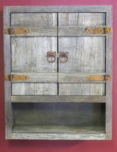 an old wooden cabinet with two doors on it