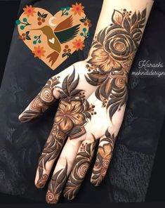 a woman's hand with henna tattoos on it