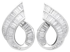 "These stunning, fine and impressive vintage diamond earrings have been crafted in 18ct white gold. Each curvilinear, scrolling earring features two paralleling tapering channel settings ornamented with thirty-two diamonds, in a combination of baguette and tapering baguette cuts. The posterior portion of the earring loop is embellished with further channel set baguette cut diamonds, completing the design. These impressive vintage earrings for pierced ears secure to the reverse with a post and hi Vintage Diamond Earrings, Diamond Bar, Wedding Jewelry Earrings, White Gold Earrings, Channel Set, Baguette Cut, Stunning Earrings, Earrings Collection, Earrings Etsy