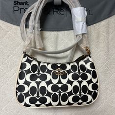 Brand New Coach Teri Black And White Bag! Number Cq674 Measurements Length: 9.5" Height: 6.0" Width: 3.0" Materials Signature Coated Canvas And Smooth Leather Fabric Lining Handle Detachable Handle With 8.25" Drop Strap Detachable Strap With 22.75" Drop For Shoulder Or Crossbr Wear Features Zip-Top Closure Inside Multifunction Pocket Two Credit Card Slots White Crossbody Baguette Bag For Shopping, White Baguette Crossbody Bag For Shopping, White Baguette Bag With Detachable Strap For Shopping, White Coach Evening Bag, White Baguette Bag With Detachable Handle For Shopping, Trendy White Coach Bags, Coach Handheld Shoulder Bag, Black And White Bags, Leather Fabric