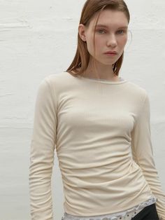 This inner piece from Atelier Nain features built-in bands at the sides, creating a naturally falling shirred point, exuding casual mood.- The shirring allowing for easy pairing with a variety of inners- Sleeves that have shirring for added detail- The string at the back neck offering various tying options for different styles* Model shots may differ from the actual product color due to shooting location, time, and graphic techniques. Refer to the product cut images for the actual color. Spring Ruched Tops For Layering, Fall Ruched Crew Neck Top, Fitted Beige Ruched Top, Beige Ruched Stretch Top, Spring Beige Ruched Top, Cream Ribbed Top For Spring, Fitted Beige Top With Ribbed Neckline, Beige Fitted Top With Ribbed Neckline, Spring Beige Tops With Ribbed Neckline