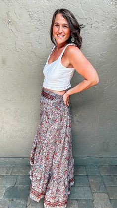 From the beach to brunch to any other summer day, give your wardrobe a boho twist with the Valerie Boho Skirt. Featuring a multi-colored paisley print with a gray background, pops of yellow, red, pink, and blue that come together in an eye-catching pattern. The pretty border detail around the edges offers a nice finished look. The hi-low cut of this bohemian maxi skirt is perfect for vacationing or every-day wear, all while offering a flattering waistband and a flowy fit that will have you feeli Hippie Floral Print Maxi Skirt For The Beach, Hippie Floral Print Maxi Skirt For Vacation, Bohemian Summer Wrap Skirt With Lining, Spring Hippie Wrap Skirt, Multicolor Bohemian Wrap Skirt For Vacation, Bohemian Summer Lined Wrap Skirt, Casual Boho Print Maxi Skirt For The Beach, Bohemian Multicolor Wrap Skirt For Vacation, Bohemian Patterned Skirt For Beach