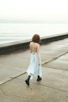 Our stylish, must-have version of the essential LBD (little ​beach dress), the Sage Maxi Dress Baby Blue is a flowing asymmetric dream that’s perfect for mid-summer events, beach days, and travel. The silhouette is inspired by the tranquil vibes of Tulum’s beaches and bustling energy of its town center. It features long straps you can wrap twice around the waist for an adjustable fit. Breathable fibers keep you cool as you lounge, explore, and indulge all summer long. Flowy Beachwear Maxi Dress With Tie Back, Summer Light Blue Cotton Maxi Dress, Light Blue Spring Beachwear Maxi Dress, Light Blue Summer Beachwear Maxi Dress, Light Blue V-neck Maxi Dress For The Beach, Sage Maxi Dress, Summer Events, Beach Dress, Asymmetric Hem