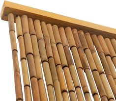 a close up view of the top of a bamboo wall hanging from a wooden frame