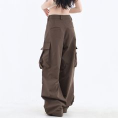 These classic-style brown pants feature a wide fit with cargo pockets Size: • S: Waist: 62cm/ 24.4 in, Length: 100cm/ 39.4 in• M: Waist: 66cm/ 26.0 in, Length: 101cm/ 39.8 in• L: Waist: 70cm/ 27.6 in, Length: 102cm/ 40.2 in• XL: Waist: 74cm/ 29.1 in, Length: 103cm/ 40.6 in• XXL: Waist: 80cm/ 31.5 in, Length: 104cm/ 40.9 inMaterial: Cotton, Polyester Baggy Brown Long Pants, Khaki High-waisted Cargo Parachute Pants, Baggy Brown Bottoms With Side Pockets, Brown Baggy Bottoms With Side Pockets, Baggy Khaki Bottoms With Flap Pockets, High Waist Brown Bottoms For Streetwear, Full Length Khaki Cargo Parachute Pants, Casual Brown Wide Leg Pants With Pockets, Full-length Khaki Parachute Pants With Cargo Pockets