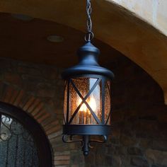 a light hanging from the side of a building with a door in the back ground