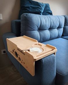 a blue couch with a wooden table attached to it's back and the seat is made out of plywood