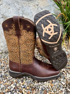 This boot is ready for a day of riding or working in the barn with its extremely durable and comfortable sole. But just because it works hard, doesn't mean it doesn't look good doing it. The upper shaft is a beautifully tooled and the bottom is a brushed mahogany. These will easily become a favorite in your closet! 10" Shaft Boot circumference 13" 1 1/4" Heel 4LR technology provides lightweight support Mesh lining Lightweight EVA midsole for shock absorption Duratread sole is extremely durable w Wide Calf Snip Toe Boots For Country Events, Wide Calf Boots With Snip Toe For Country Events, Country Style Ankle Moto Boots For Ranch, Rustic Moto Boots With Reinforced Toe For Fall, Rustic Reinforced Toe Moto Boots For Fall, Square Toe Work Boots With Reinforced Toe For Outdoor, Outdoor Work Boots With Reinforced Square Toe, Western Style Moto Boots With Round Toe For Outdoor, Western Round Toe Boots