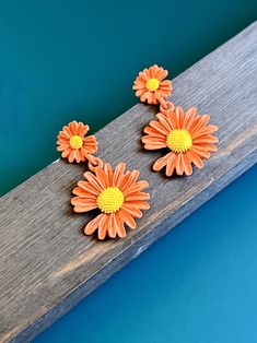 These vintage orange stud earrings are a must-have for any fashion-forward individual. The stunning orange color brings a pop of brightness to your outfit, making you stand out from the crowd. Eye-catching Design: The earrings feature beautiful spring daisy flowers that are sure to catch everyone's attention. Perfect Gift: These vintage earrings make the perfect gift for any occasion. Surprise your loved ones with this unique and thoughtful present. The high-quality construction ensures durability, so you can wear them every day without worrying about damage or wear and tear. These earrings are versatile enough to be worn with casual or formal attire, making them a perfect addition to your jewelry collection. Add some floral elegance to your style with these chic vintage orange flower stud Spring Orange Drop Earrings, Trendy Yellow Flower Earrings, Summer Orange Flower-shaped Jewelry, Trendy Orange Drop Earrings, Orange Flower Earrings For Gift, Orange Flower Shaped Earrings For Summer, Orange Drop Earrings For Spring, Orange Flower-shaped Earrings For Summer, Vintage Flower Earrings For Spring