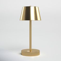 a gold lamp on a white background with the light turned off to show its dim lighting