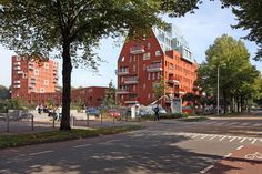 an empty street in front of some red brick buildings with windows on the top floor