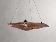 a wooden light hanging from a ceiling fixture with two lights on each side of it