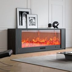 a living room with a fire place in the center and pictures on the wall next to it