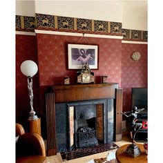 a living room filled with furniture and a fire place in front of a painting on the wall