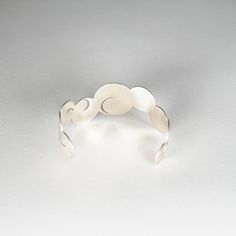 Product Description : Why is it so EXPENSIVE? Product Story General Product Information This silver bangle was created with expert skill by craftsmen at a metalwork carving studio with a history of more than 200 years. Jardin means garden in French, and the design was inspired by the traditional Japanese garden style of karesansui, or dry landscape garden. Karesansui is a garden style that expresses magnificent natural scenery of mountains and seas by using stones, sand, plants, and trees withou Japanese Garden Style, Dry Landscape, Product Story, Craft Markets, Metal Products, Natural Scenery, Metal Crafts, Traditional Crafts, Tea Ceremony