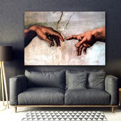 two hands touching each other on a painting