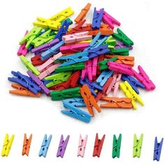 many different colored plastic clips on a white surface with scissors in the middle one is cut into smaller pieces