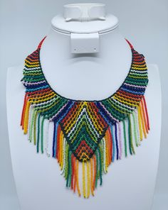 This beautiful beaded necklace is hand-woven by the women of the Embera Chami Indigenous Tribe of Colombia Adjustable Beaded Necklaces With Fringe And Round Beads, Adjustable Handmade Beaded Necklaces, Traditional Beaded Necklaces For Beach With Colorful Beads, Artisan Adjustable Beaded Necklaces With Colorful Beads, Artisan Beaded Necklace With Adjustable Length, Artisan Adjustable Colorful Beaded Necklaces, Round Beaded Necklaces For Festivals, Artisan Beaded Adjustable Necklaces, Artisan Beaded Adjustable Necklace