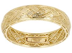 a yellow gold ring with an intricate design on the inside, and a name engraved on the outside