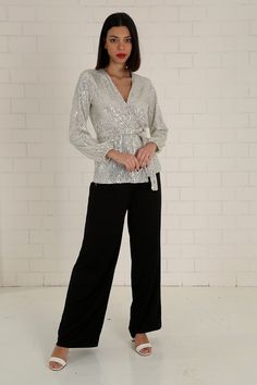 "The white sequined wrap blouse has a modern and stylish look. Our glamorous blouse with its sparkle is an extremely stylish and elegant choice for formal evenings such as cocktails, weddings and all-night/day invitations. The blouse, which is a coupon piece that you should have in your closet, can be combined with sequined twin trousers, baggy and tight classic trousers or jeans. It easily adapts to your body with the shawl model. It is tied around the waist with a belt. S/36 Length from underarm: 43cm/16.9\" Length from Shoulder: 66cm/25.9\" M/38 Length from underarm: 44cm/17.3\" Length from Shoulder: 67cm/26.4\" L/40 Length from underarm: 45cm/17.7\" Length from Shoulder: 68cm/26.8\" XL/42 Length from underarm: 46cm/18.1\" Length from Shoulder: 69cm/27.2\" 2XL/44 Length from armpit: 47c Glamorous V-neck Party Blouse, Festive V-neck Evening Blouse, Glamorous V-neck Blouse For Party Season, Glamorous Formal V-neck Blouse, Glamorous Contrast Sequin Blouse For Night Out, Glamorous Sequin Blouse For Night Out, Elegant Long Sleeve Sequin Dress For Night Out, Glamorous V-neck Blouse, Chic Embellished Blouse For Wedding