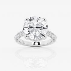 a round cut diamond ring on a white background