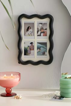 a white table topped with pictures and candles