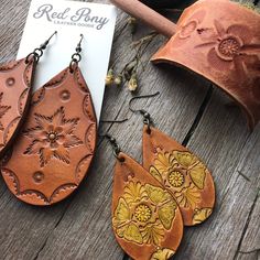 "Hand tooled leather earrings. Premium veg tanned leather. Handmade from start to finish. We love and take great care in what we do and it translates to every detail of your beautiful leather piece. These earrings aren Extra Large at approximately 3\" in length and 1.75\" wide. These are made to order. Hand tooled and dyed in a rich caramel brown with a floral motif and antiqued finish. These look great with any modern boho styles. If you love an extra large statement earring, these are for you! Bohemian Hand-tooled Leather Earrings, Hand Tooled Leather Earrings For Gift, Hand Tooled Leather Earrings As Gift, Handmade Rustic Leather Earrings, Handmade Rust Leather Jewelry, Rustic Hand Tooled Leather Earrings, Everyday Hand Tooled Leather Jewelry, Everyday Hand-tooled Leather Jewelry, Rustic Leather Stamped Jewelry