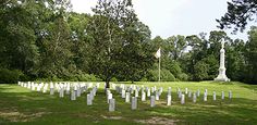 a cemetery with many headstones in the grass