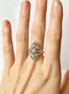 Once in a Blue Moon vintage finds! Art Deco Filigree Ring // Antique Remake Contains a total of 12 flawless CZ gemstones in an art deco geometric setting.  Size:  5-10 US Metal purity: Solid 925 Sterling Silver Weight: 2.6 g Band width: 2.0 mm Free Shipping, comes in ring box ready to gift! ~Why Cubic Zirconia?~ CZ is a lab created stone with the closest resemblance to Diamond. In recent years, developers have succeeded in adding color to CZ, making it an affordable alternative to almost any gem Art Deco Style Oval Cluster Ring As Gift, Heirloom Diamond Ring As Gift, Heirloom Diamond Ring For Gift, Art Deco Hand Set Diamond Jewelry, Heirloom Style Anniversary Crystal Ring With Diamond Cut, Diamond White Hand Set Diamond Ring For Anniversary, Hand Set White Gold Promise Ring, Hand Set Diamond Ring For Anniversary, Heirloom Diamond White Ring