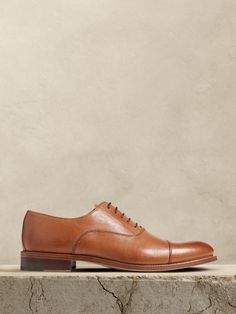 The perfect dress shoe, these timeless leather oxfords have a subtle, cap-toe construction, beautifully crafted for us in Portugal of exceptional, timeless leather.  Leather uppers.  Waxed laces.  Leather soles.  Made in Portugal.  Whole and half sizes. Trendy Hats, Brown Dress Shoes, Trendy Hat, Stylish Scarves, Shoe Inspo, Leather Dress Shoes, Cool Sunglasses, Dress Shoe, Leather Cap