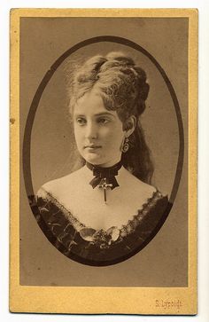 an old photo of a woman with long hair