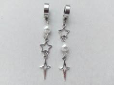 The earrings are decorated with white faux pearl beads. Silver-colored brass pendants in the shape of stars are attached to the earrings. These earrings are without ear piercing The earrings are fastened with stainless steel clips. Earring length - 7.0 cm (2.8 inches) Earrings  are packed in a gift box RECOMMENDATIONS FOR CARE: Do not wet, do not drop, and store in a dark box! - Remove jewelry before exercising, swimming, showering and sleeping. - Avoid contact with moisture such as make-up, moi Y2k Accessories Earrings, Cute Star Earrings, Star Clips, Piercings Goth, Alt Jewelry, No Piercing Earrings, Earrings No Piercing, Brass Pendants, Korean Earrings