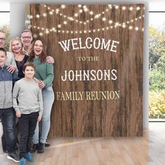 a family posing for a photo in front of a wooden sign that says, welcome to the johnsons family reunion